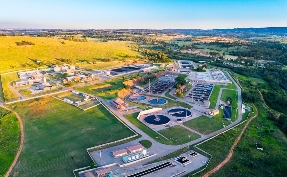 Technician monitoring industrial water treatment equipment to ensure proper chemical dosing and system efficiency.